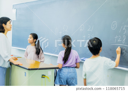 Elementary school students taking lessons in a classroom Elementary school students taking lessons in a classroom 118065715