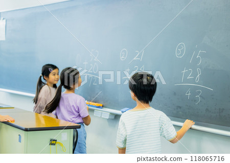 Elementary school students taking lessons in a classroom Elementary school students taking lessons in a classroom 118065716
