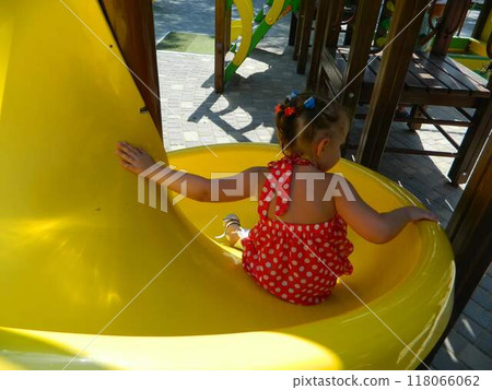 Kids having fun in ferris wheel with chains, carousel ski flyer in amusement park in Targoviste, Romania, 2020. High quality photo 118066062