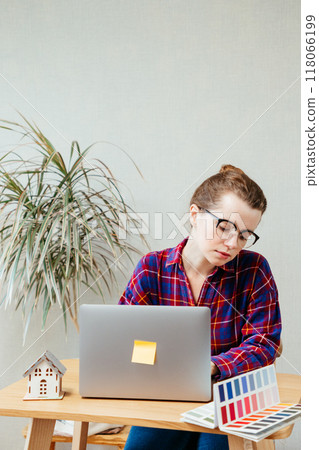 female architect is holding mock-up house, scale model building, thinking sketch for design courses.  118066199