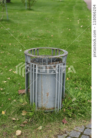 public trash can on city street filled with garbage. plastic waste in trash can container. 118066204