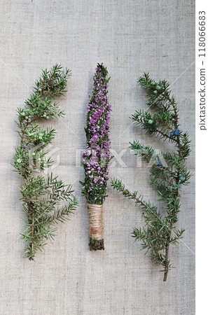 Freshly handcrafted heather and juniper bundle laid on rustic fabric. Ideal for natural home decor or aromatherapy Freshly handcrafted heather and juniper bundle laid on rustic fabric. Ideal for natural home decor or aromatherapy 118066683