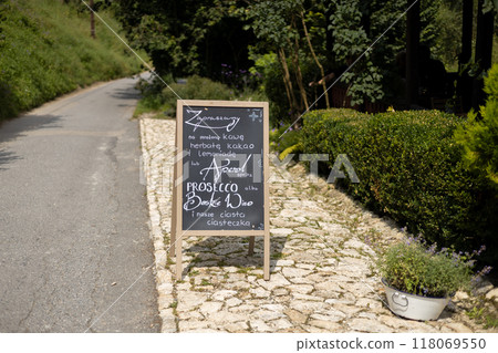 Restaurant sidewalk chalkboard sign board with text. Old Signboard with posts on the street. Cafe signage sign isolated outdoors. Blackboard advertising. Restaurant sidewalk chalkboard sign board with text. Old Signboard with posts on the street. Cafe signage sign isolated outdoors. Blackboard advertising. 118069550