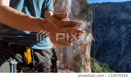 Man climbs with magnesium powder, hands closeup. 118070584