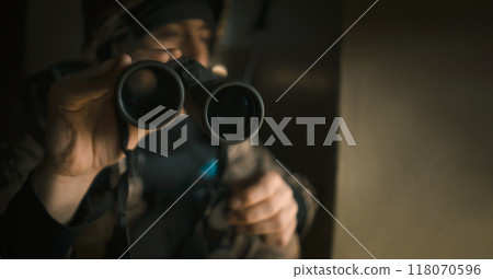 A Man with a binocular and in the military uniform. A Man with a binocular and in the military uniform. 118070596