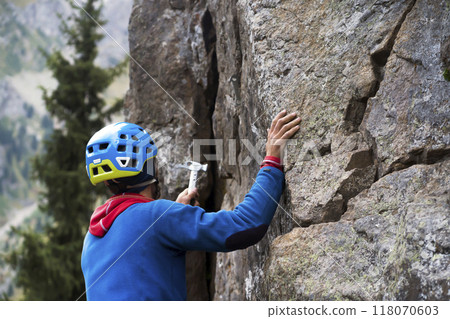 Man is climbing, hiking in the mountains. 118070603