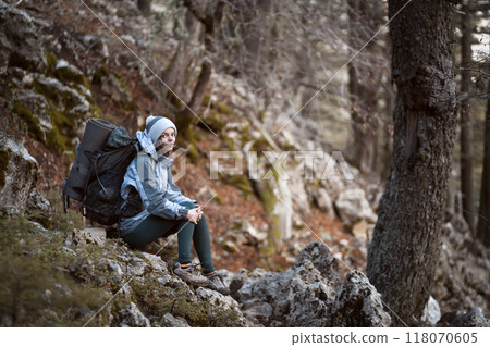 Girl is hiking, trekking with a backpack in the mountains. 118070605