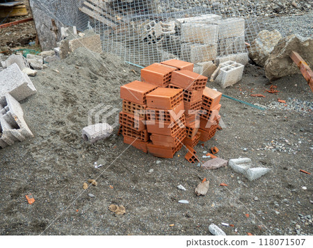 Building blocks on the ground. Material for the construction of warm houses. Construction from hollow concrete blocks. Building blocks on the ground. Material for the construction of warm houses. Construction from hollow concrete blocks. 118071507