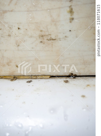Mold in the bathroom. Black dots of mold and yellow plaque. Black mold Dirt on tiles. Requires cleaning. Before using cleaning products. 118071615