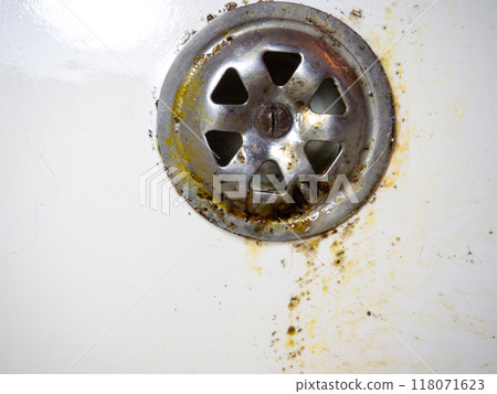 Bathroom drain dirty. Siphon element. Plumbing. Mold on bathroom enamel. Black dots of mold and yellow plaque. Requires cleaning. Before using cleaning products. 118071623