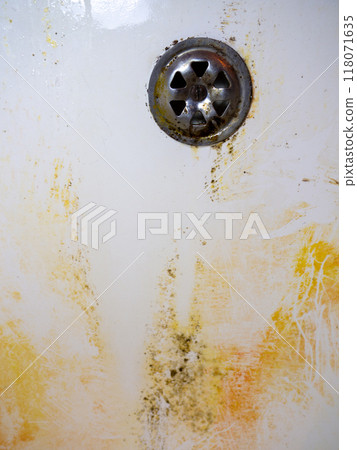 Mold on bathroom enamel. Black dots of mold and yellow plaque. Requires cleaning. Before using cleaning products. 118071635