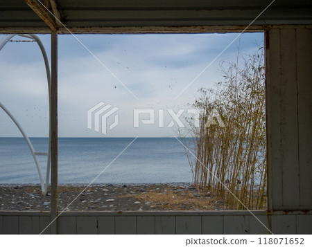 View from the window of a wooden hut. Old building on the beach. 118071652