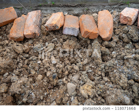 Broken sidewalk. Conducting the cable underground. Cable laying work. Communications in the city. Digged paving bricks. 118071668