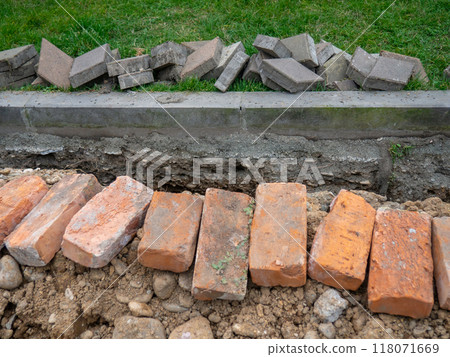 Broken sidewalk. Conducting the cable underground. Cable laying work. Communications in the city. Digged paving bricks. Broken sidewalk. Conducting the cable underground. Cable laying work. Communications in the city. Digged paving bricks. 118071669