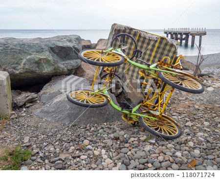 Broken walking car on pedals. The attraction doesn't work. Entertainment for tourists.  Four wheel vehicle 118071724