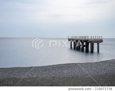 Reinforced concrete sticking out of the water. Remains of an old bridge in the sea. Ruined pier. Abandoned. Reinforced concrete sticking out of the water. Remains of an old bridge in the sea. Ruined pier. Abandoned. 118071736