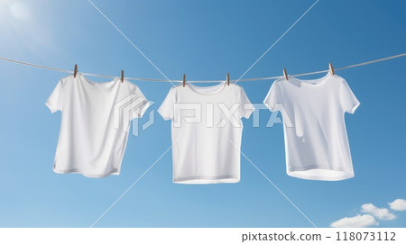 Three white t-shirts hanging on clothesline against blue sky with clouds. Mock up 118073112