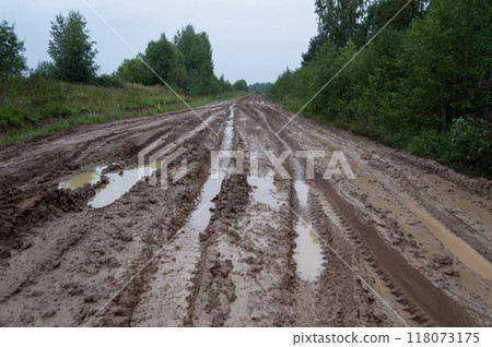Messy country dirt road after rain 118073175