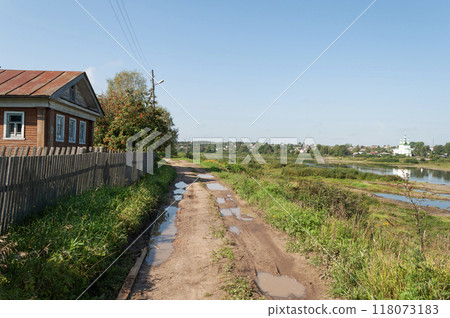 Dirt road with puddles after rain 118073183