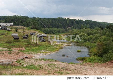 Village on the bank of a small river Village on the bank of a small river 118073188