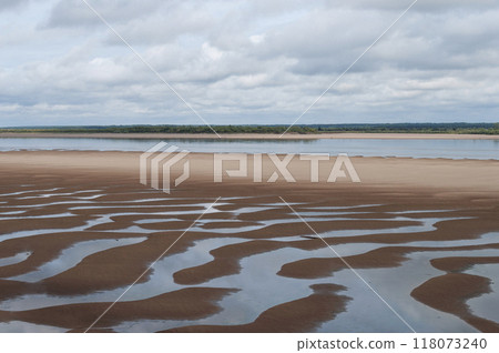 Shallow river with a large sandy beach 118073240
