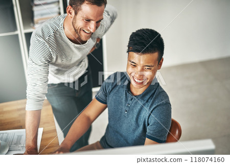 They get more done by working together. Cropped shot of two designers working together on a project in an office. They get more done by working together. Cropped shot of two designers working together on a project in an office. 118074160