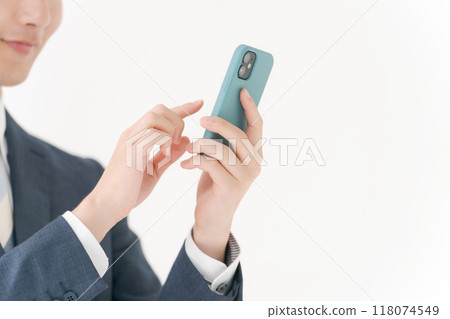 Hand of a man manipulating a smartphone 118074549