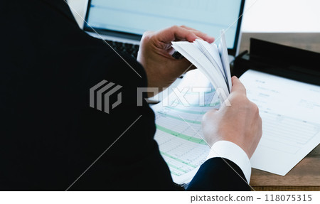 Hands of a businessman digitizing documents 118075315