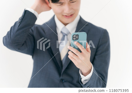 Business man worried about seeing a smartphone 118075395