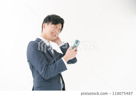 Business man worried about seeing a smartphone 118075487