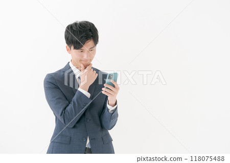Business man worried about seeing a smartphone 118075488