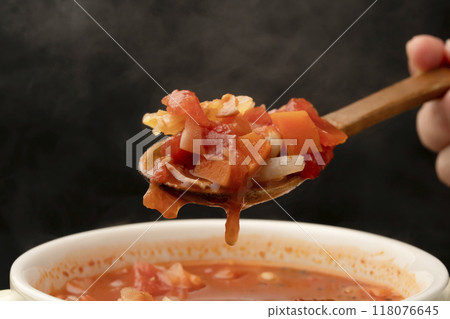Minestrone soup cup lifted with spoon 118076645