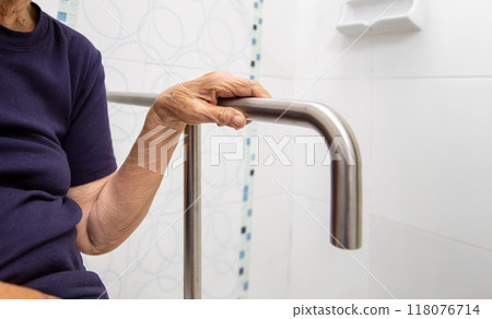 Elderly Woman Gripping Bathroom Safety Rail Elderly Woman Gripping Bathroom Safety Rail 118076714