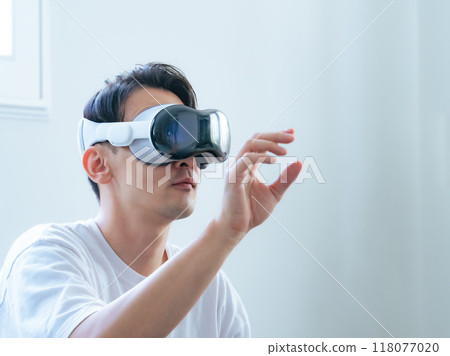 A man using VR goggles to control 3D images 118077020
