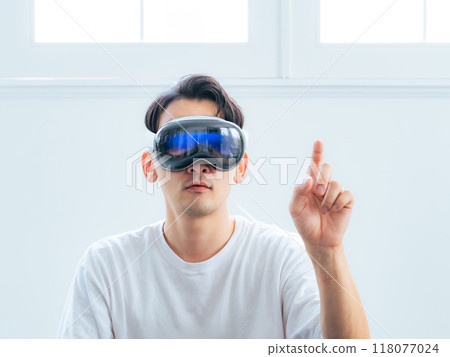 A man using VR goggles to control 3D images A man using VR goggles to control 3D images 118077024