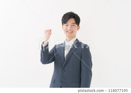 A man in a suit showing a guts pose 118077195