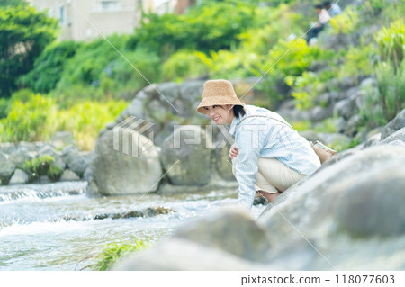 女人在河邊玩耍，女人在旅行，女人在享受假期 118077603
