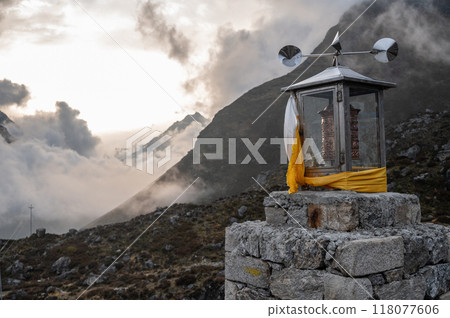 Wind powered prayer wheel in Kyanjin Gompa village of Nepal. You will often see wind prayer wheels at a different spot along the way where the wind power is strong. 118077606