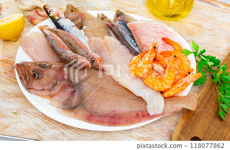 Raw megrim fish served with parsley 118077862