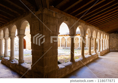 Shaded arched gallery around courtyard at Sant Llorenc de Morunys monastery 118077871