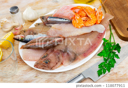 Raw megrim fish served with parsley 118077911