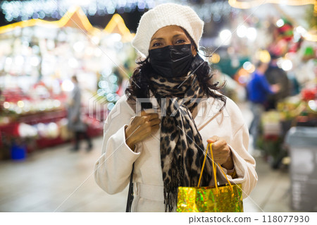 Portrait of a Latin American woman in a mask who came to a Christmas fair Portrait of a Latin American woman in a mask who came to a Christmas fair 118077930