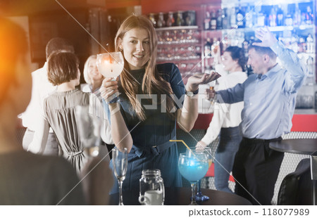 Girl drinking cocktail and dancing 118077989