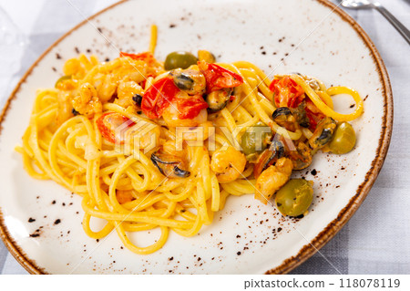Pasta macaroni with seafood contains tiger prawns, shell mussels, spices and white sauce Pasta macaroni with seafood contains tiger prawns, shell mussels, spices and white sauce 118078119
