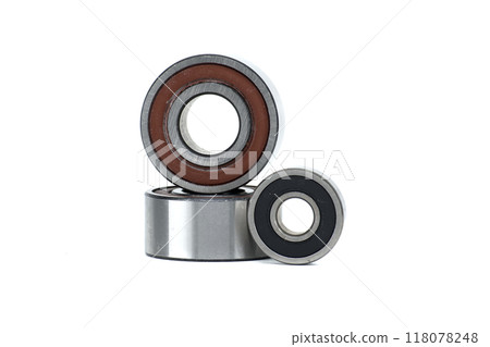 Close-up of three metal ball bearings of different sizes isolated on a white background Close-up of three metal ball bearings of different sizes isolated on a white background 118078248