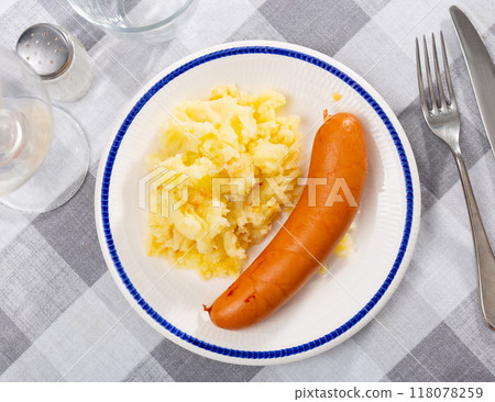 Sausages served with potatoes and cabbage Sausages served with potatoes and cabbage 118078259