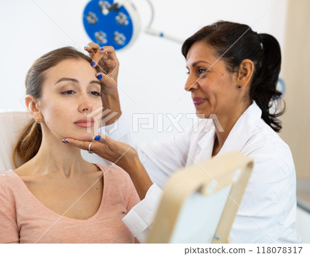 Woman having consultation at aesthetic medicine clinic Woman having consultation at aesthetic medicine clinic 118078317