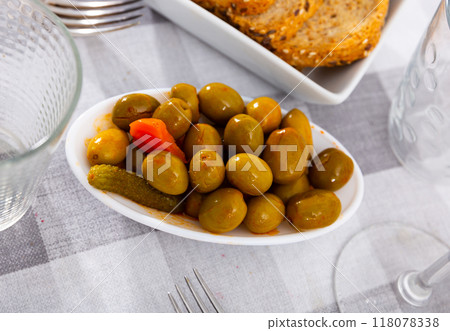 Marinated green olives with cucumbers and carrots served in bowl closseup Marinated green olives with cucumbers and carrots served in bowl closseup 118078338
