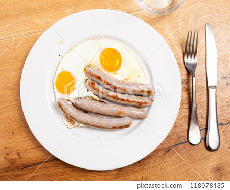 Breakfast with sunny side up eggs and grilled butifarra sausages Breakfast with sunny side up eggs and grilled butifarra sausages 118078485