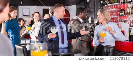 Man talking to woman on corporate party 118078513